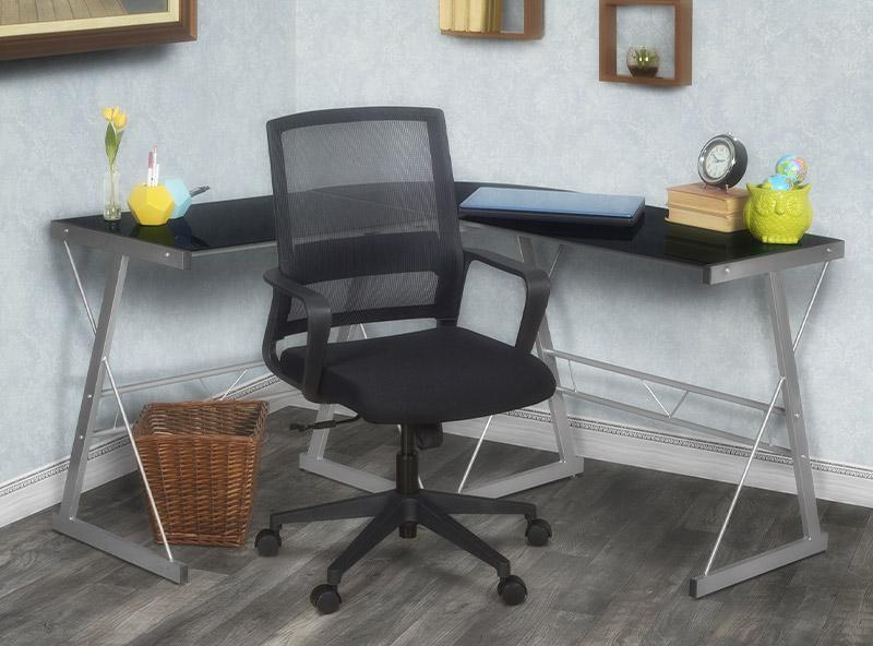 black mesh swivel chair with black L desk with a glass top in an home office