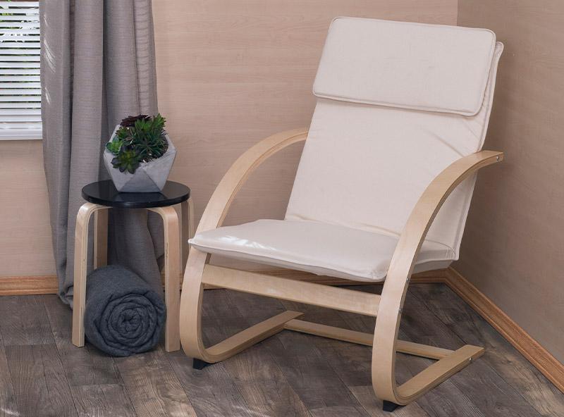 Niche mia side table holding a pot next to an bentwood beige recliner chair