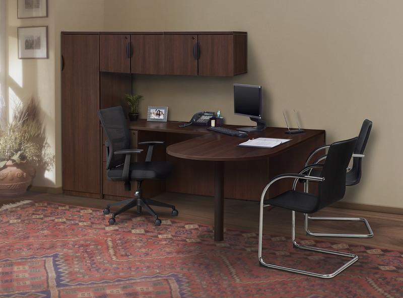 Office desk with return and overhead cabinets and storage with one black swivel chair and 2 black side chairs