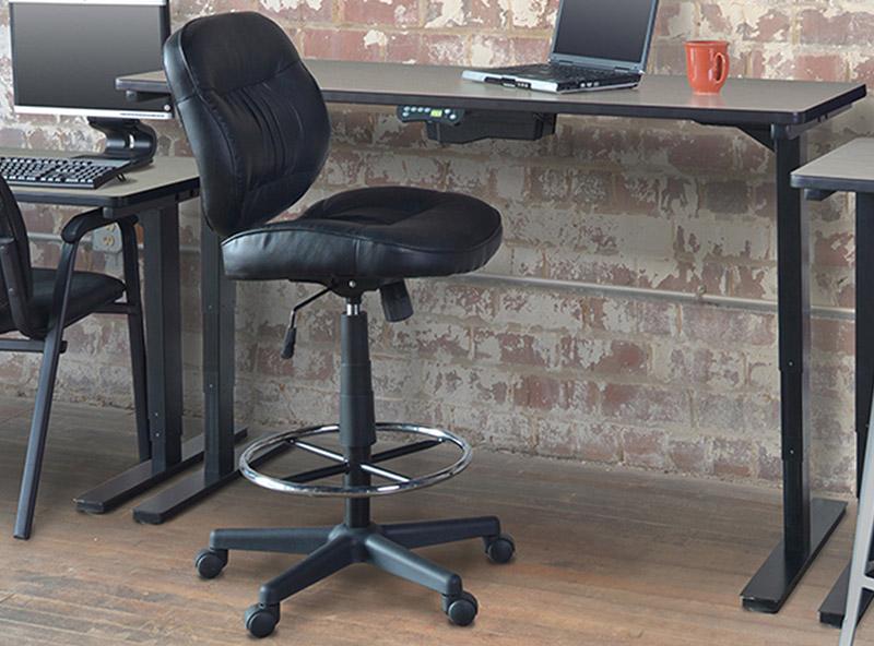 Tall black swivel rolling stool with a back rest next to a programmable desk and a computer