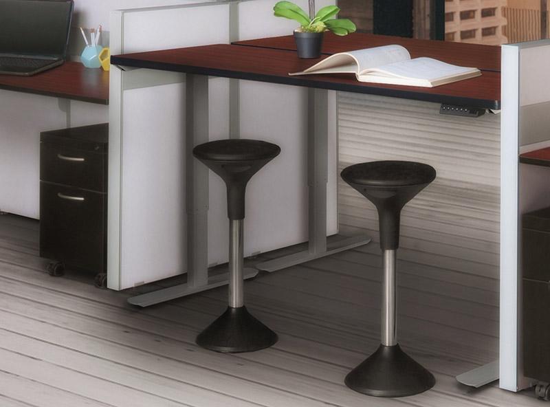 Black adjustable active stools below a sit and stand cherry desk with a grey base