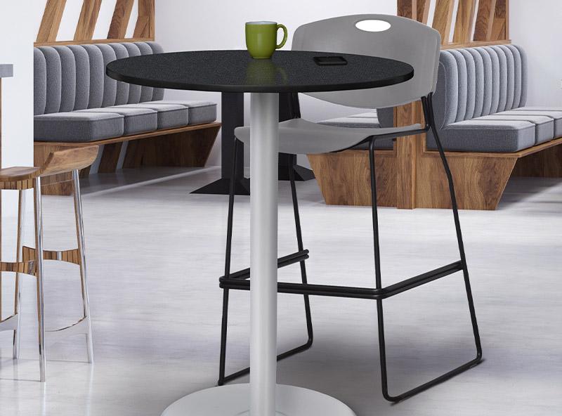 cafe round table with a platter base next to multiple grey stools