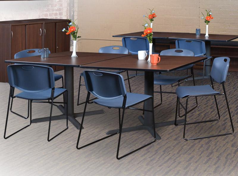 5 Breakroom tables with black x bases and blue zeng stack chairs in a banquet room